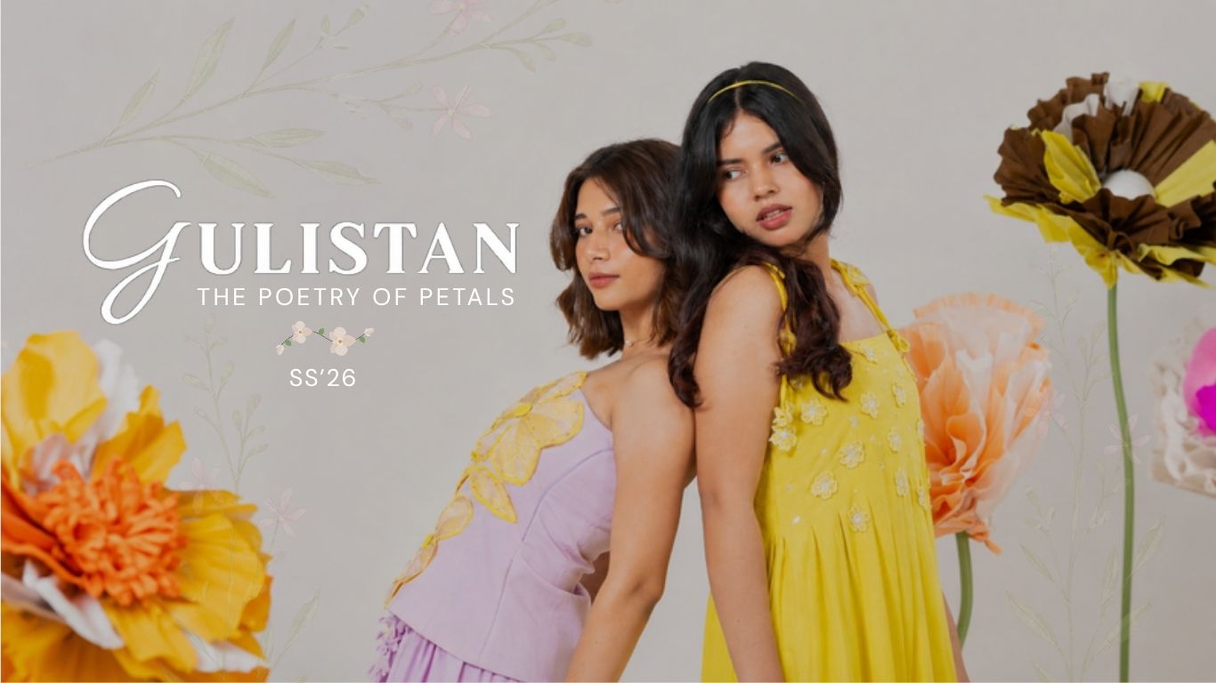 Two women in floral dresses standing back-to-back with flowers around them, featuring the brand 'Gulistan'.